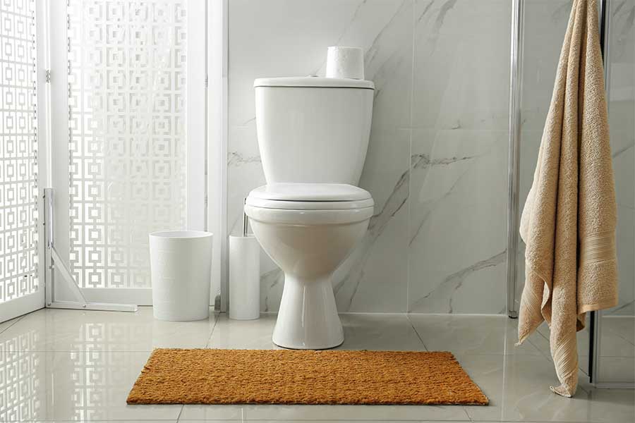 White two-piece toilet in a modern Las Vegas, NV bathroom